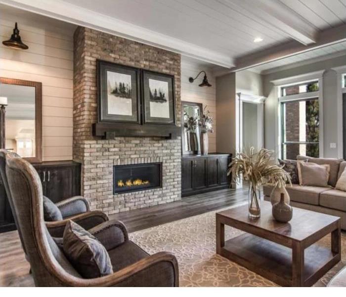 Living room with in wall brick fireplace showcasing proper fireplace safety
