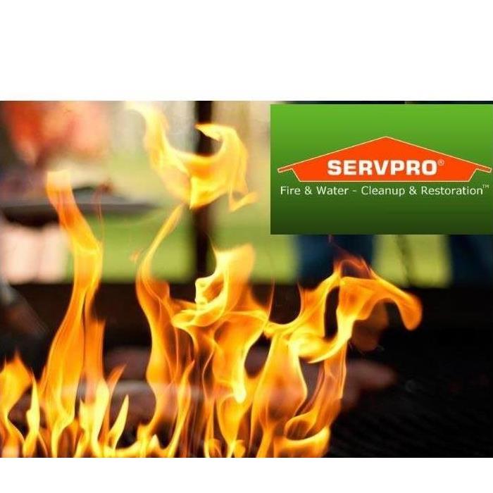 Flame in front of a living room out of focus in the background with Servpro logo on top right corner